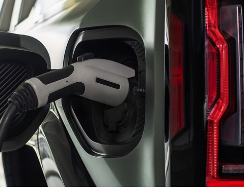 Close up of charging port with charger plugged in on a GMC Hummer EV SUV - Levalley GMC in Benton Harbor MI